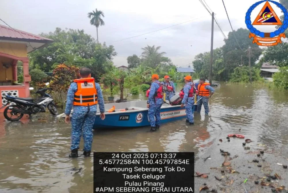 Anggota APM melakukan operasi memindahkan mangsa banjir, pada Jumaat. Foto APM Seberang Utara 