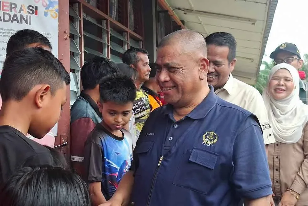 Saarani menyantuni mangsa banjir yang ditempatkan di PPS SK Matang Gelugor.