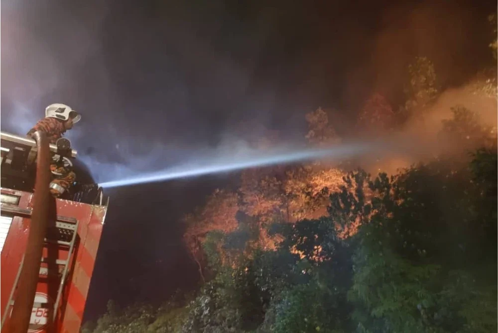 Anggota bomba sedang memadamkan kebakaran hutan di Gombak pada Sabtu. - Foto: JBPM Selangor