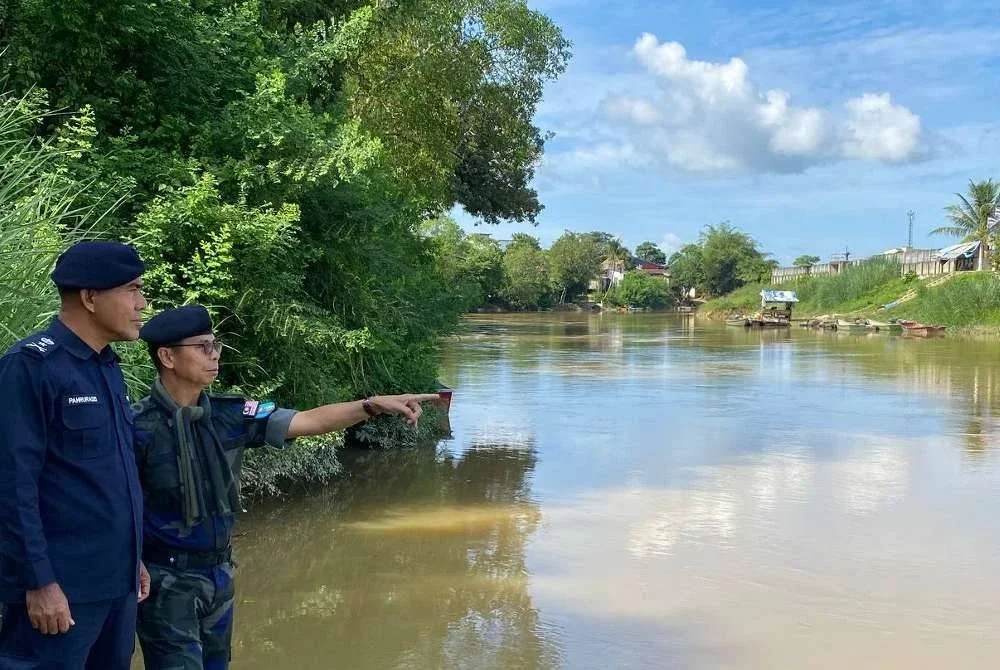 Ijid (kanan) semasa melakukan tinjauan di sekitar kawasan pangkalan haram di sepanjang Sungai Golok, Rantau Panjang.