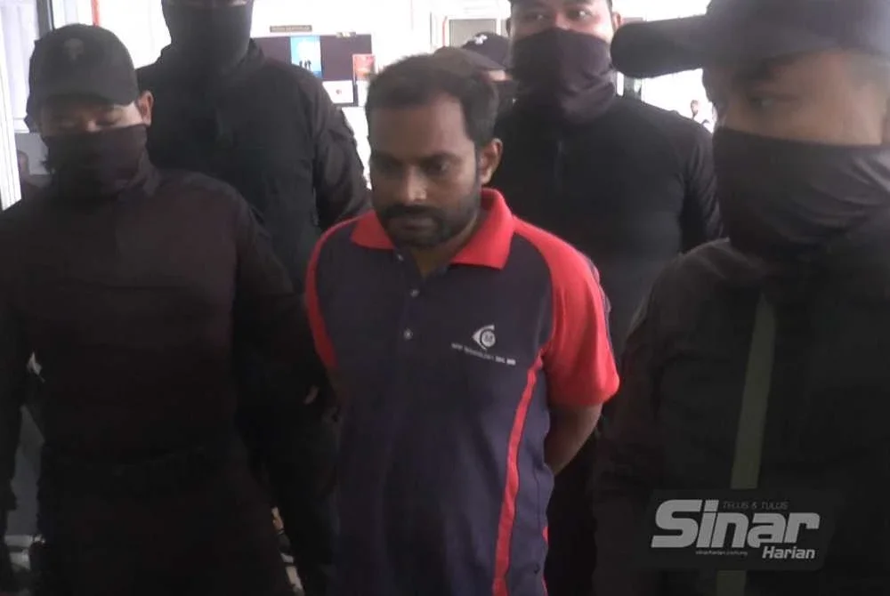 Tertuduh diiringi pegawai polis ketika dibawa ke Mahkamah Bukit Mertajam pada Selasa.