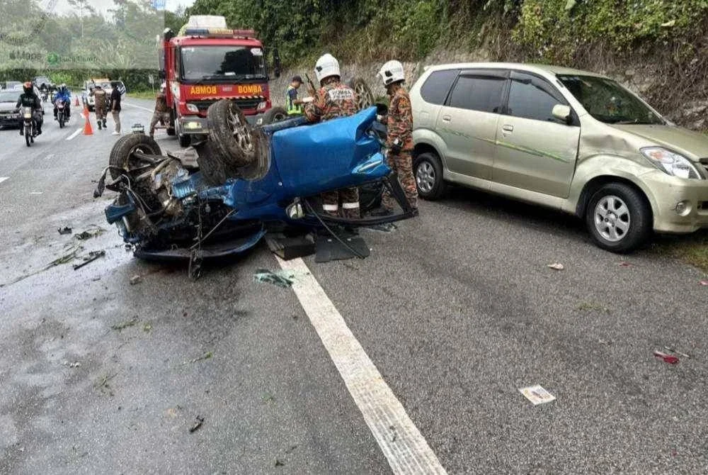 Anggota bomba membantu mengeluarkan mangsa yang tersepit di dalam kereta yang terbalik di Kilometer 44.2 Lebuhraya Kuala Lumpur- Karak (KLK) dekat Genting Sempah, Bentong pada Ahad. FOTO JBPM PAHANG