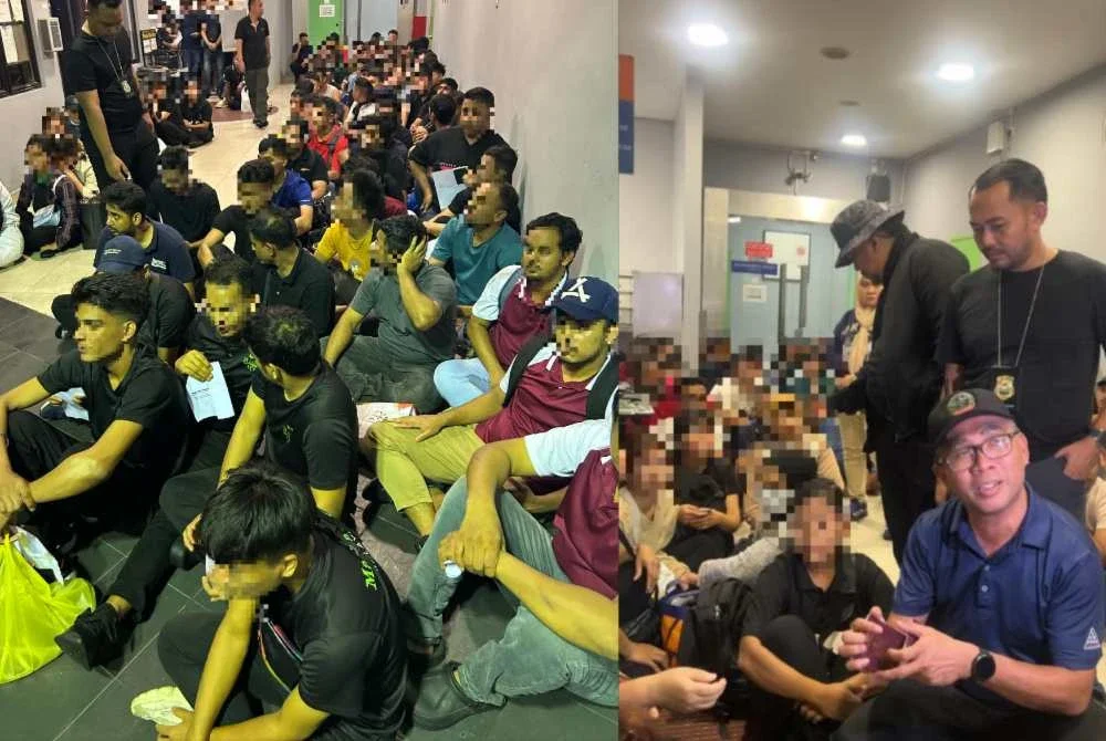 Khairrul Aminus (duduk, kanan) ketika memeriksa warga asing yang ditahan dalam operasi penguatkuasaan JIM di Pelangi Damansara, Petaling Jaya di sini malam tadi.