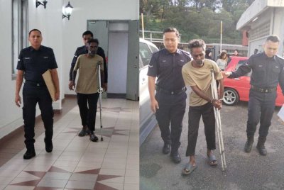 Tertuduh (tengah) diiringi polis ketika tiba di mahkamah pada Jumaat.