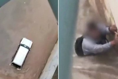 Seorang lelaki dihanyutkan kepala air di Sungai Klang, berhampiran Pintasan Saloma petang Isnin. Foto Bernama