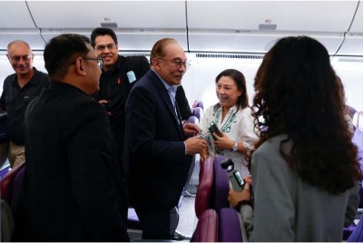 Anwar (tengah) bersalaman dengan wakil media yang akan membuat liputan bagi siri lawatan rasmi dan kerja beliau ke Ethiopia, Afrika Selatan dan Kenya. - Foto: Bernama 