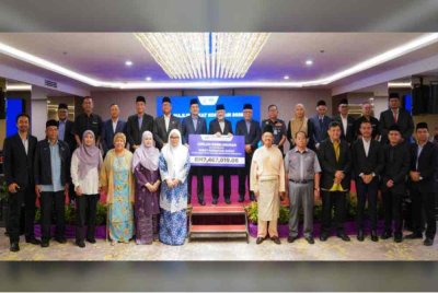 Amrin (belakang, enam dari kiri) bersama wakil 19 koperasi yang menunaikan zakat perniagaan masing-masing.