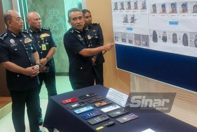 Adzli (kiri) pada sidang media di Ibu Pejabat Polis Kontinjen Kedah pada Rabu.