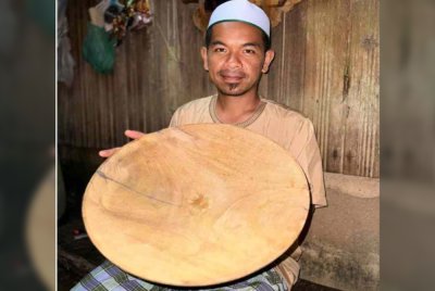 Shahfakrimee menunjukkan salah satu dulang emas diperbuat daripada kayu merbau yang banyak digunakan oleh pendulang.