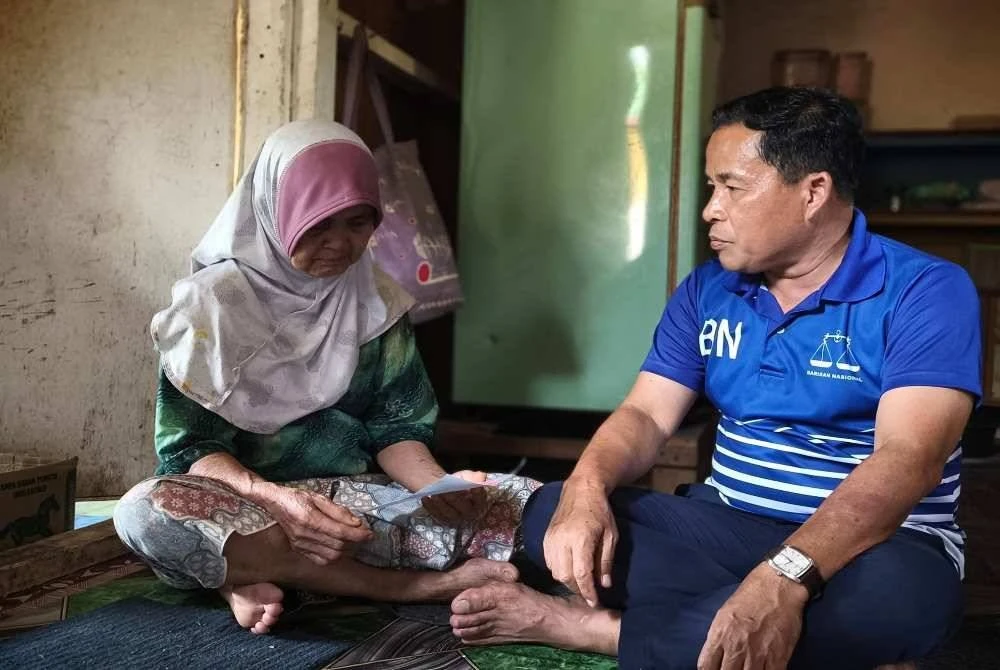 Cikgu Rusman (kanan) pada program Ziarah Kasih PDM Kampung Membakut dan PDM Pimping sempena kempen PRN Sabah. - Foto Facebook Rusman Dulamit 