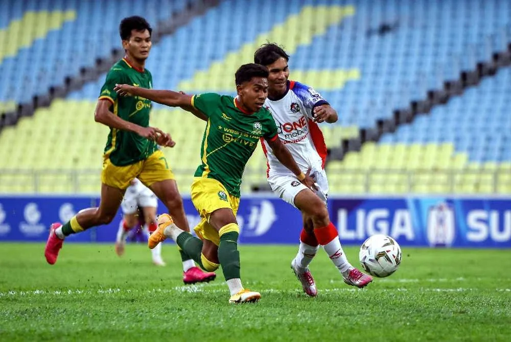 Pemain pasukan Imigresen FC, Mohammad Fayadh Mohd Zulkifli Amin (tengah) diasak pemain pasukan PDRM FC, Muhammad Amirul Wa’ie Ya’acob (kanan) pada perlawanan Liga Super di Stadium Negeri Batu Kawan pada Ahad. Foto Bernama