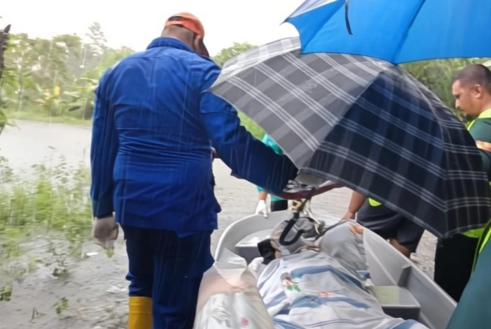 APM Bachok meredah banjir sedalam 0.7 meter bagi membantu memindahkan seorang pesakit strok yang terlantar di Kampung Gelung Badak, Jelawat, Bachok pada Ahad. Foto: APM