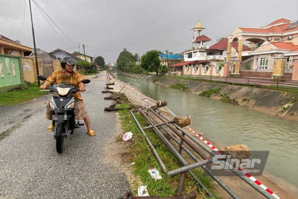 Fauzi menunjukkan lokasi runtuhan yang dibimbangi boleh mendatangkan bahaya kepada pengguna jalan raya serta penduduk. Foto: HAZELEN LIANA KAMARUDIN