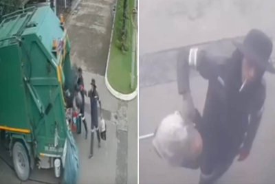 Rakaman CCTV menunjukkan pekerja pembersihan mengangkat plastik sampah dipercayai mengandungi jongkong emas di Bangkok, Thailand. - Agensi