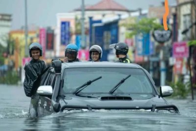 Penduduk dan kenderaan terjejas susulan air naik di Taman Bendahara, Pengkalan Chepa, akibat hujan lebat berterusan. Foto: Bernama