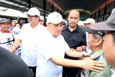 Hajiji (tengah) beramah mesra bersama pengundi DUN Kiulu semasa hadir pada majlis bersama rakyat di Dewan Terbuka Kiulu, Tuaran.