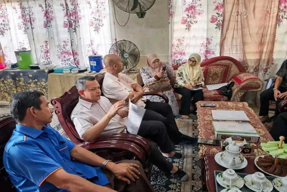 Aminuddin (dua dari kiri) semasa menziarahi guru terbabit di Merlimau, Melaka pada Ahad.