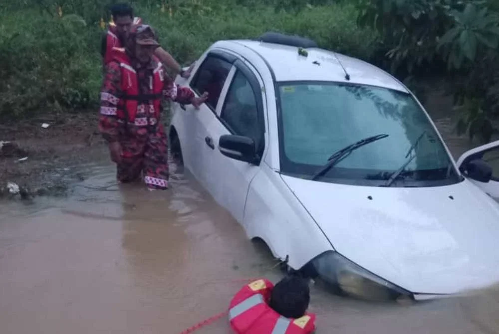 Seorang warga emas maut dan menjadi korban banjir kedua di negeri ini selepas kereta dinaiki dihanyutkan air deras di Kampung Batu Lima, Jalan Jedok, Tanah Merah pada Rabu. - Foto JBPM
