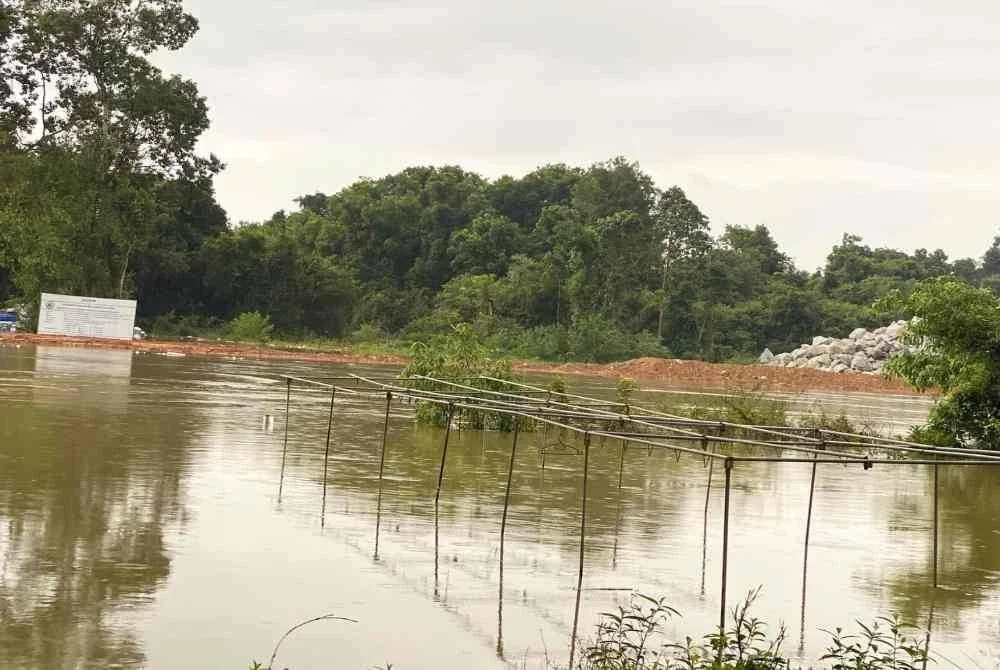 Air Sungai Golok mulai melimpah di kawasan kedai dan rumah Mohd Hirwan yang hanya berjarak sekitar 100 meter dari sungai terbabit. - Foto Sinar Harian/Hazelen Liana Kamarudin