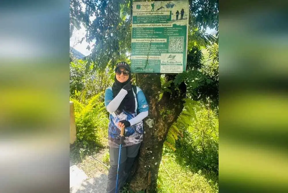 Zamira di papan tanda memperingatkan tentang bahaya penyakit ketinggian (AMS).