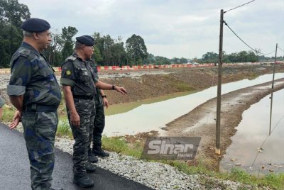 Ahmad Radzi (dua dari kiri) melihat paras air di PLSB berhampiran Pos PGA Pak Teh Kana. Foto: ADILA SHARINNI WAHID