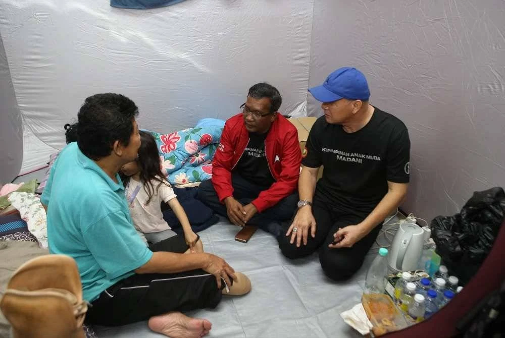 Zuraidi (dua kanan) menyampaikan sumbangan kepada mangsa banjir di PPS Sekolah Kebangsaan Seri Perdana, Alor Setar.