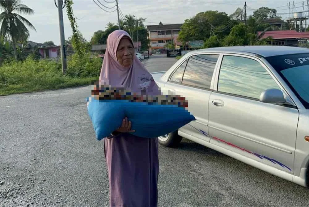 Siti Rokiah memangku jenazah cucunya sepanjang perjalanan meredah banjir menggunakan pacuan empat roda.