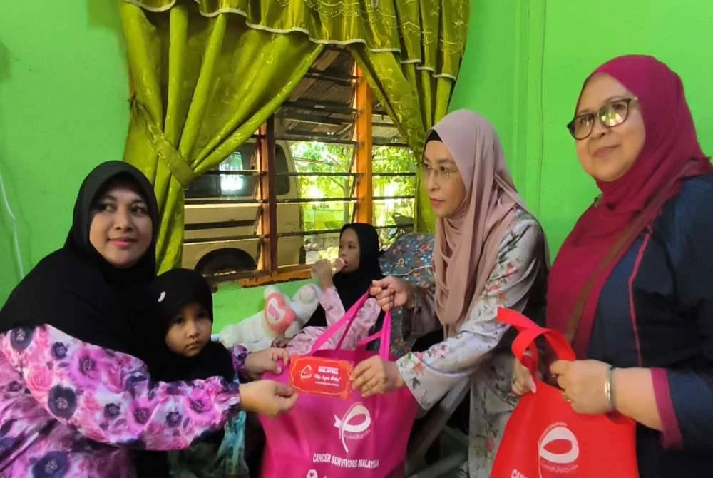 Zuraini (dua kanan) menyampaikan sumbangan susu khas, wang tunai, barangan keperluan dapur serta katil pesakit bagi keselesaan Nur Iman Syamimi.