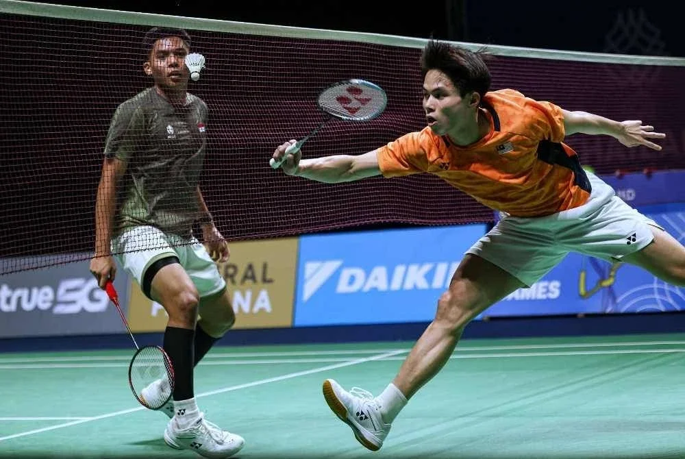 Justin Hoh beraksi menentang Mohd Zaki Ubaidillah dalam acara berpasukan lelaki. FOTO: Bernama