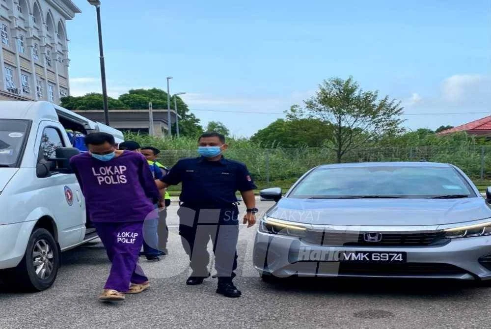 Nor Hizam dibawa oleh anggota polis tiba di Mahkamah Sesyen Kota Bharu pada Khamis. Foto:SINAR HARIAN