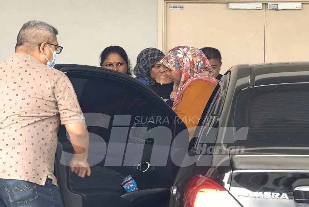 Isteri Allahyarham (tudung hitam) yang tidak dapat menahan kesedihan di Jabatan Forensik Hospital Rembau.