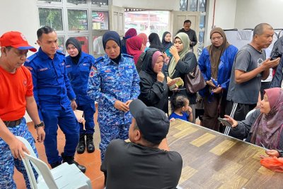 Anggota APM membantu mendaftar mangsa banjir yang berada di salah satu PPS yang dibuka di daerah ini.