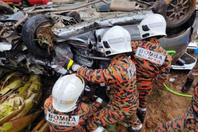 Perjalanan dua beranak berakhir tragedi apabila kenderaan dinaiki terbalik sebelum terjunam ke bawah tebing jalan selepas bertembung dengan Toyota Lexus di Kampung Batu Melintang, Jeli Khamis. Foto: JBPM