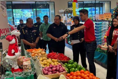 Hazimin (tiga dari kiri) meninjau harga bekalan sempena SHMMP Krismas di Jaya Grocer di Klebang pada Selasa.