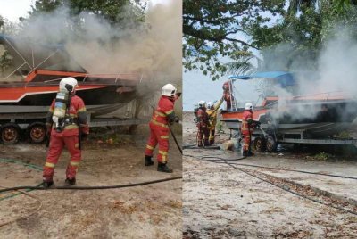 Anggota bomba sedang memadam api dalam kebakaran melibatkan sebuah bot di Teluk Kumbar.