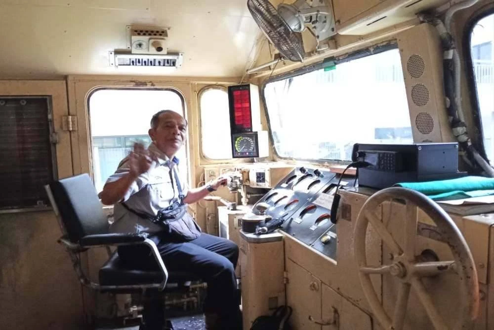 Pemandu tren ES, Suki Hussin, 56, melambai kepada penumpang sebelum mmemulakan tren terakhir ES di Stesen Keretapi JB Sentral.