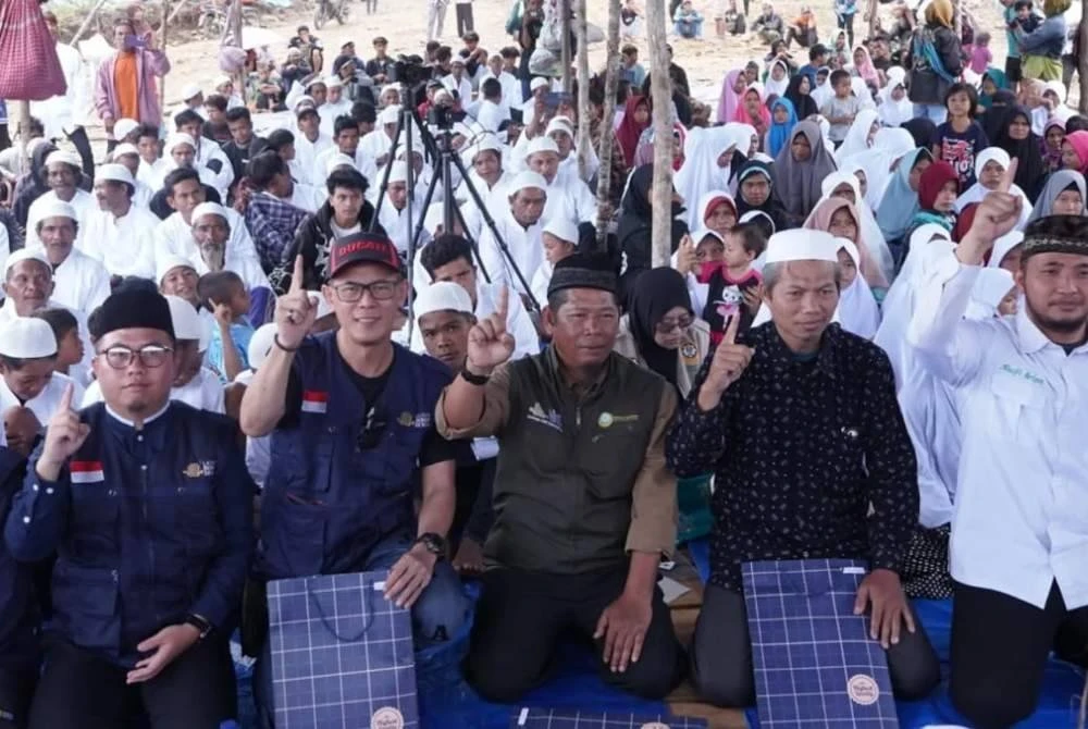 KOH DONDY (dua dari kiri) bergambar bersama ratusan penduduk suku Tau Taa Wana di Morowali Utara, Indonesia selepas mereka memeluk Islam baru-baru ini.