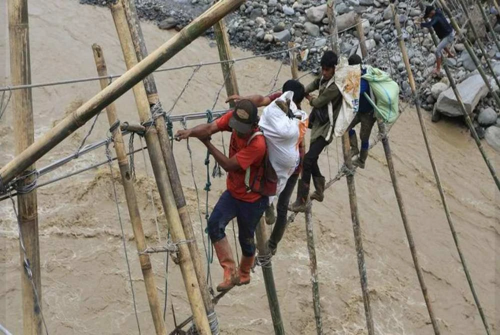 Belia Acheh terpaksa menggunakan laluan sementara yang berbahaya selepas jambatan asal rosak akibat banjir.