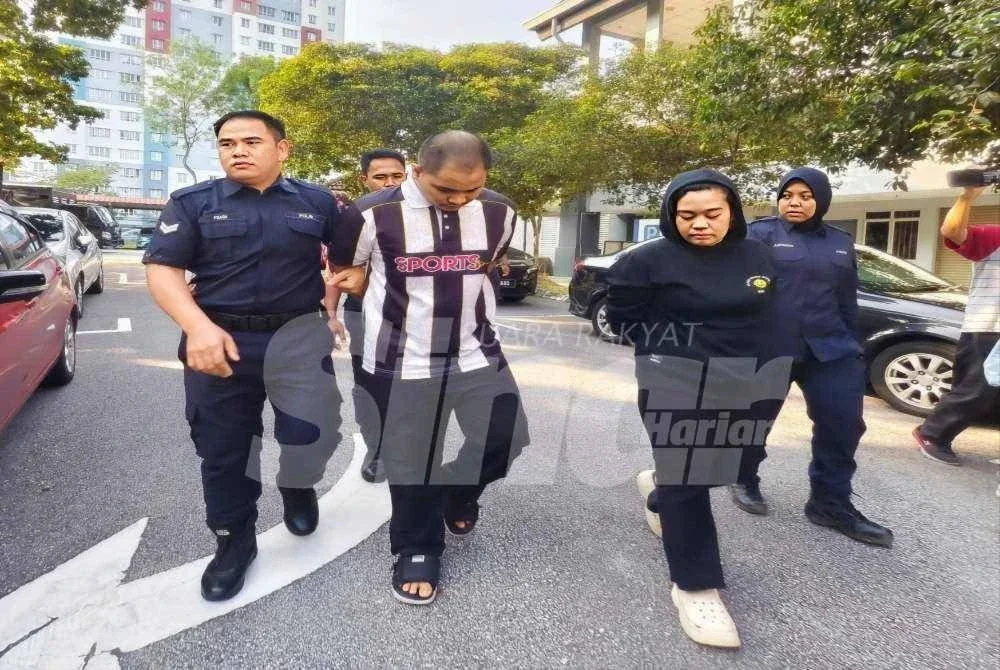Dayang Dan Masran dibawa polis ketika tiba di mahkamah