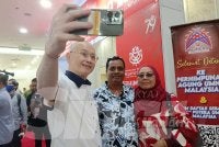 Ka Siong (kiri) melayan perwakilan yang ingin berswafoto bersamanya.