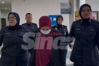Nor Hasmal Hazwani (tengah) didakwa atas 25 pertuduhan pecah amanah membabitkan wang bayaran balik empat peminjam Mara.
