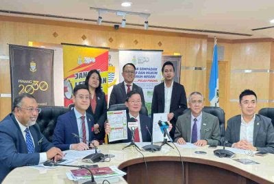 Kon Yeow (duduk, tengah) dan beberapa barisan Exco Kerajaan Negeri menunjukkan Warta Kerajaan Pulau Pinang dalam sidang akhbar di Komtar pada Rabu.