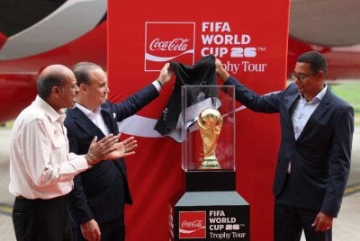 Legenda Piala Dunia dari Brazil, Gilberto Silva (kanan), Selman (tengah) dan Ketua Setiausaha Kementerian Belia dan Sukan, Datuk Dr Nagulendran Kangayatkarasu bersama Trofi Piala Dunia Fifa selepas tiba di Pusat Penerbangan Serantau Skypark. Foto Bernama