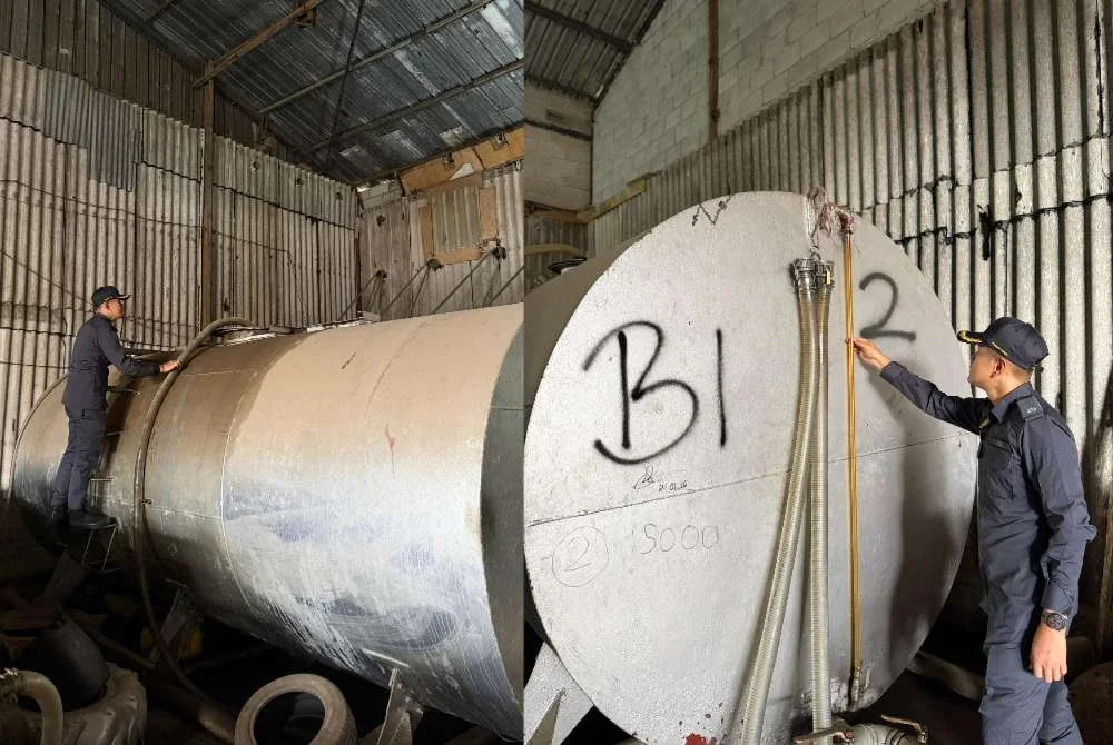 Anggota KPDN memeriksa skid tank ketika menyerbu sebuah kilang di Kulai pada Rabu. Foto: KPDN Johor