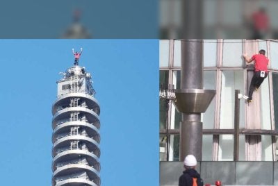 Pendaki tebing Amerika Syarikat, Alex Honnold, mengangkat tangannya dari puncak bangunan Taipei 101 selepas berjaya memanjat bebas mercu tanda itu tanpa tali atau peralatan keselamatan di Taipei pada 25 Januari 2026.-AFP