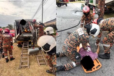 Anggota bomba cuba menyelamatkan mangsa yang dihimpit sebuah jentolak mini di Jalan Bintang, Taman Koperasi Bahagia.