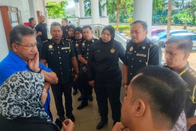 Khalid (kiri) selepas hadir mengikuti prosiding di Kompleks Mahkamah Alor Setar pada Isnin.