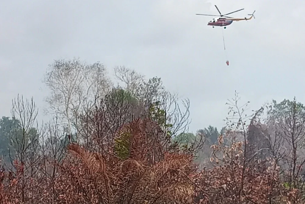 Operasi pengeboman air pada hari keenam kebakaran tanah gambut di Taman Bayu Damai, Pengerang, Kota Tinggi.