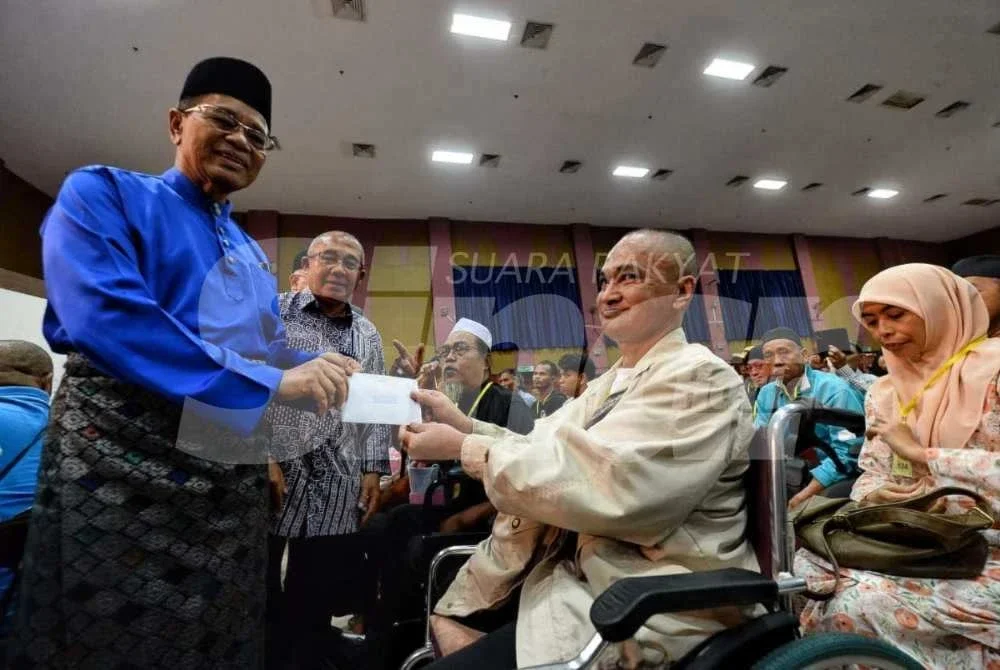 Mohamad Zamri bersyukur menerima zakat daripada Andalusia Travel pada majlis penyerahan oleh Sh Mohamed Puzi yang ditemani Ibrahim.