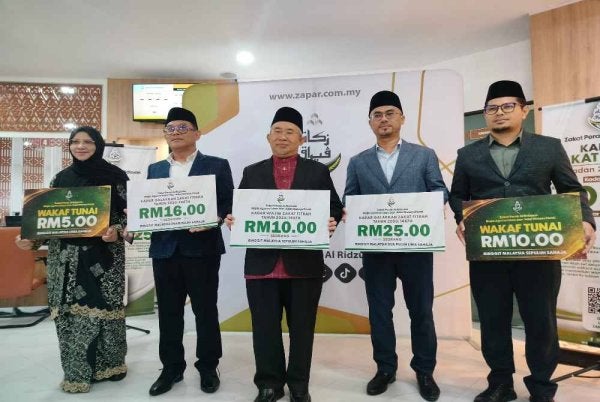 Zamri (tengah) bersama Syamsul Hazeman (dua dari kanan) dan Ahmad Nazim (dua dari kiri) menunjukkan plakad kadar zakat fitrah di Perak untuk tahun 1447 Hijrah bersamaan 2026 Masihi bagi setiap individu selepas sidang media berkenaan.